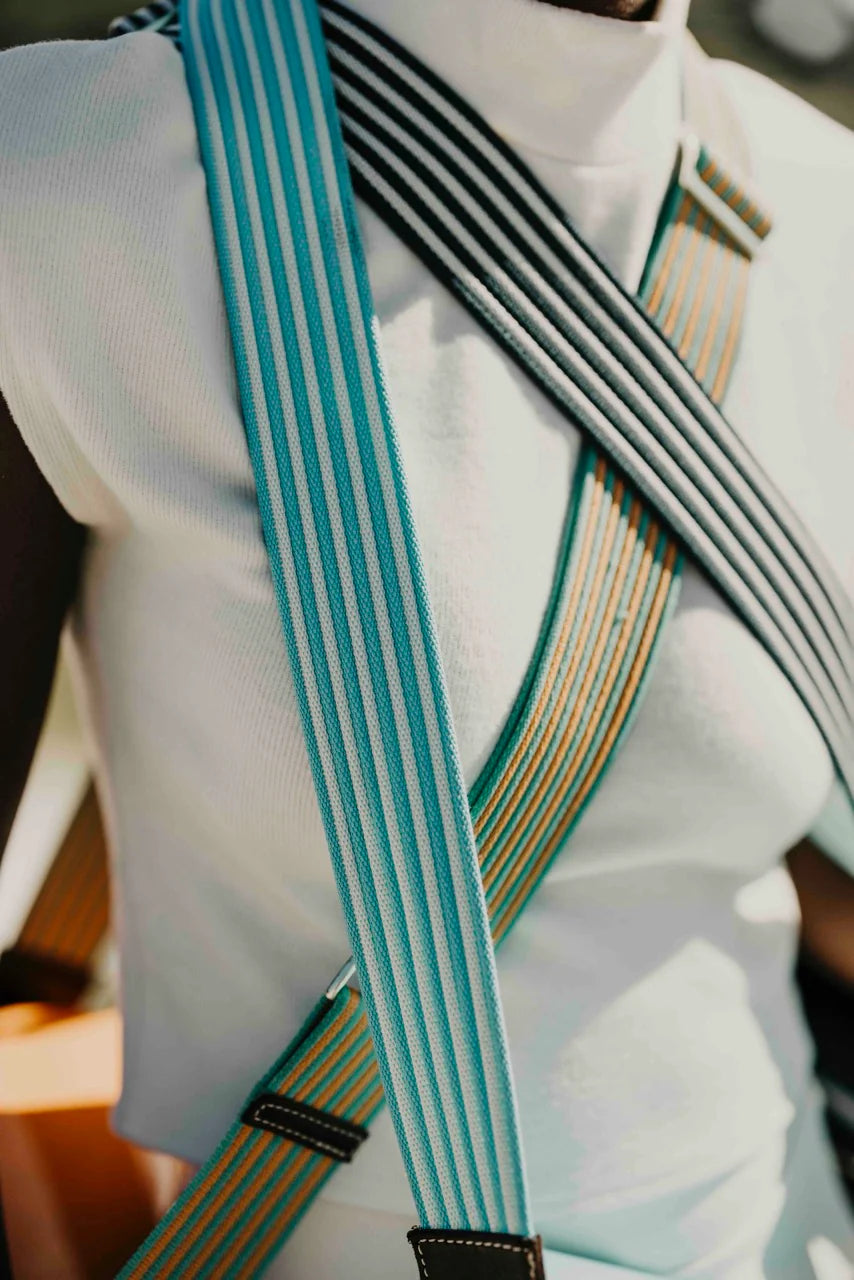 Close-up of a person wearing suspenders with a blurred background