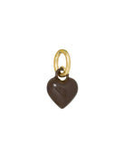 Heart-shaped charm with gold ring on a white background