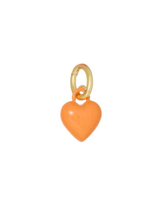 Heart-shaped charm with gold ring on a white background