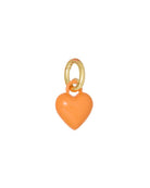 Heart-shaped charm with gold ring on a white background
