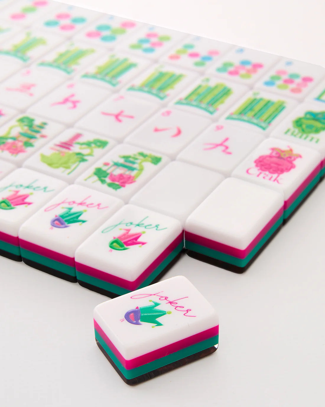 Decorative cookies with colorful designs and text on a white surface