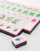 Decorative cookies with colorful designs and text on a white surface