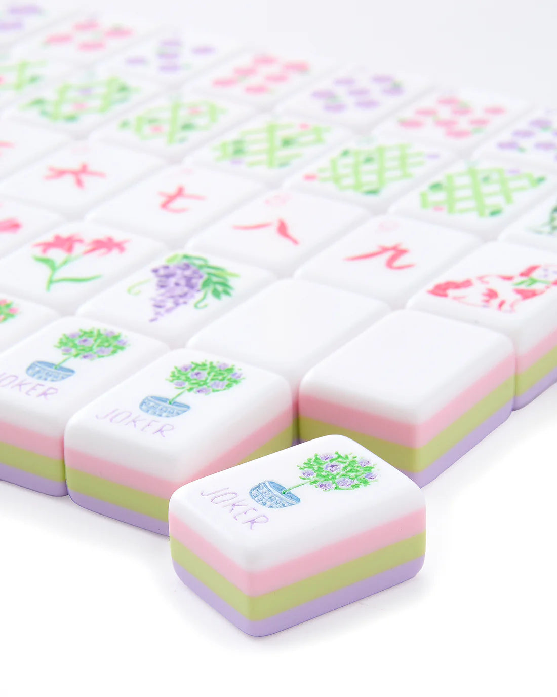 Colorful plasticine blocks with floral designs and text on a white background