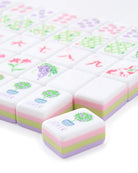 Colorful plasticine blocks with floral designs and text on a white background