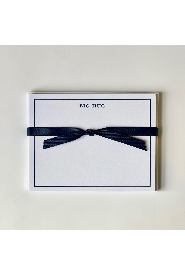 Card with 'BIG HUG' text and a navy ribbon on a light gray background
