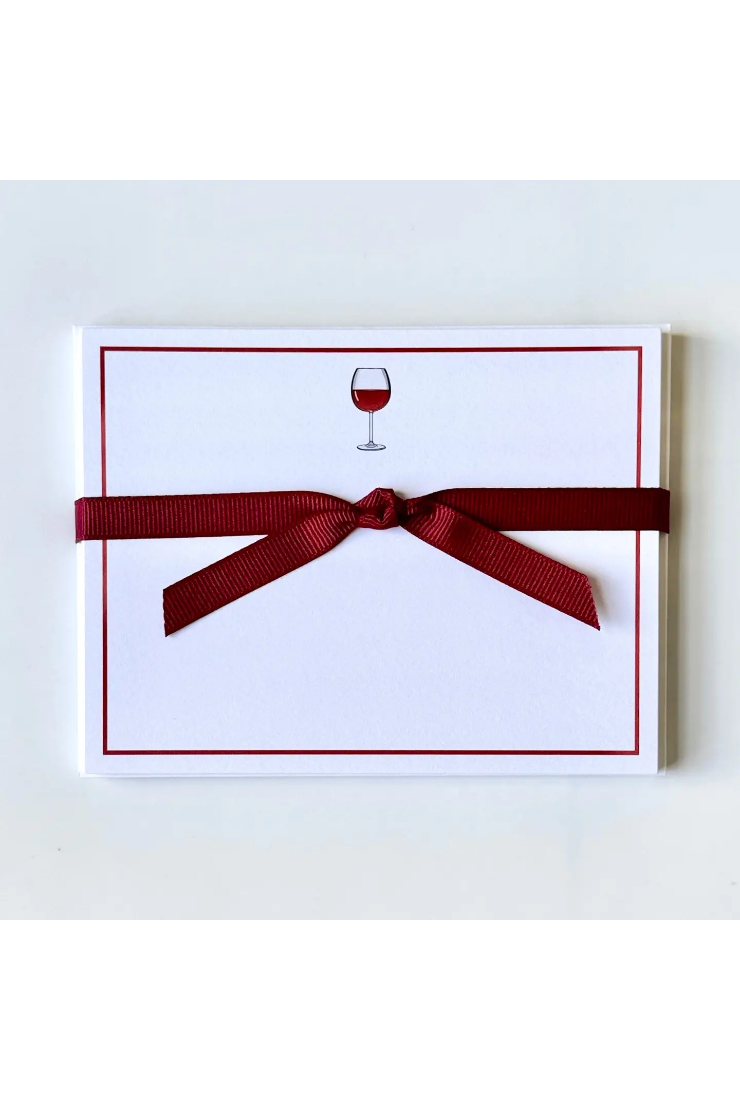 White card with red border and wine glass symbol, tied with a red ribbon on a white background
