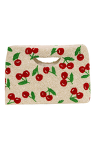 Beige clutch bag with red cherry pattern on a white background