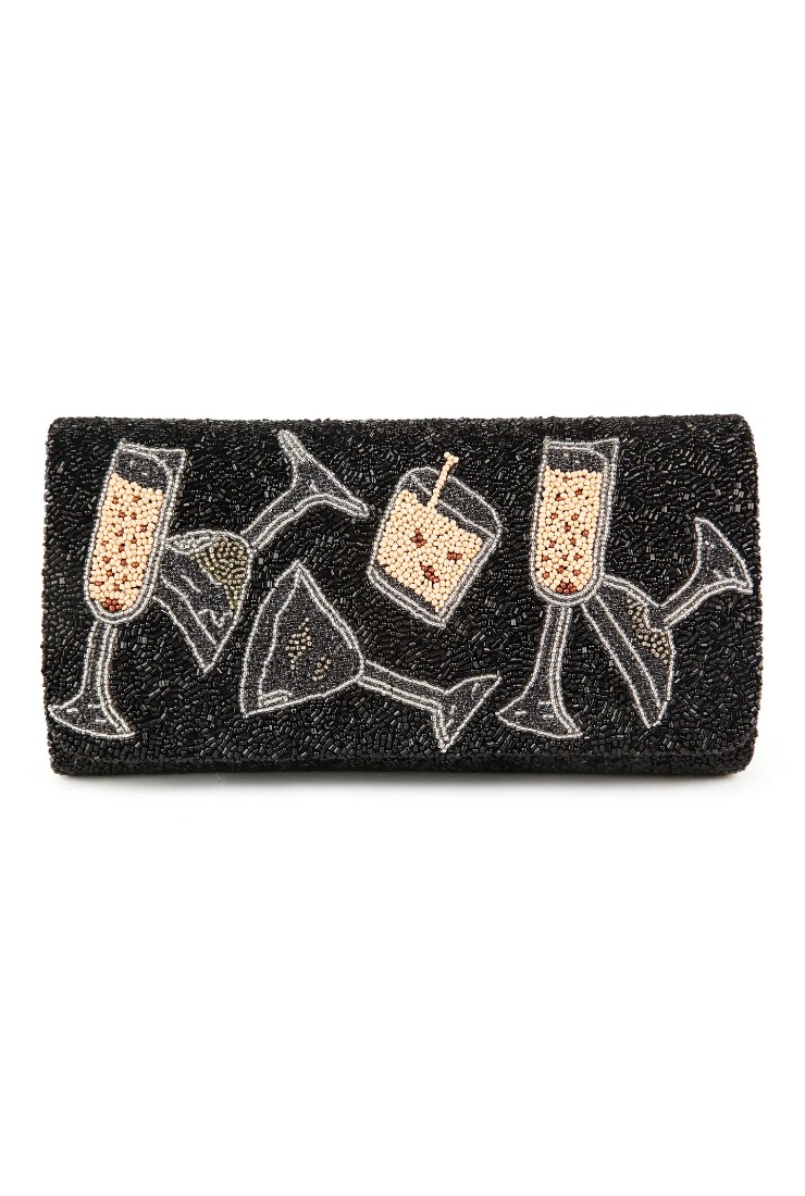 Black clutch bag with champagne glass designs on a white background