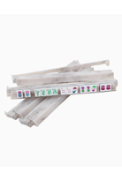 Stack of white sticks with colorful labels on a white background