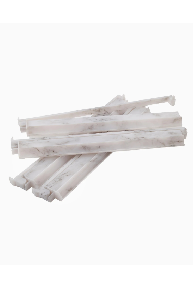 Stack of white marble-like sticks on a white background
