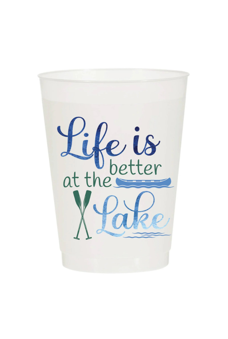 A white plastic cup featuring the printed phrase 'Life is at the Lake' in blue and green lettering, accompanied by a fishing rod graphic, on a plain white background.