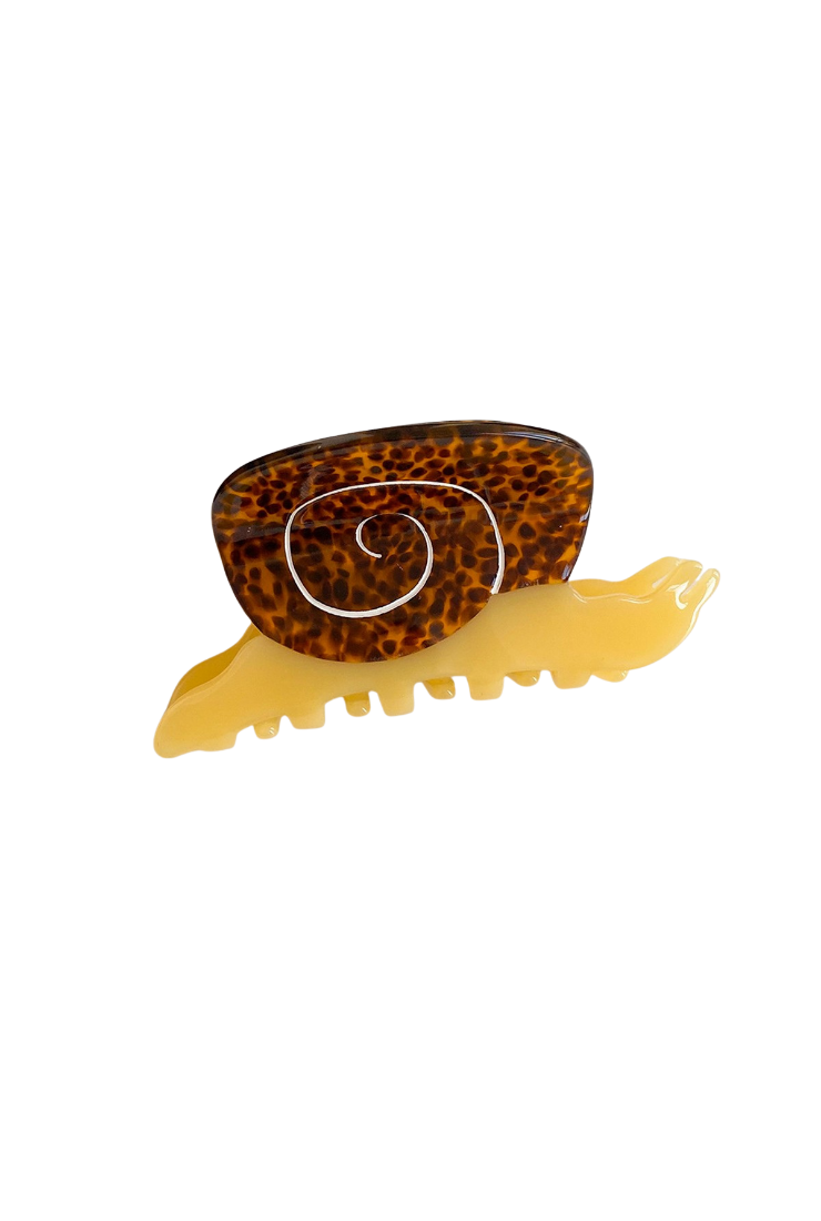 A novelty hair claw clip shaped like a spiral snail, featuring a brown and black leopard-patterned shell on a translucent yellow body, shown against a plain white background.