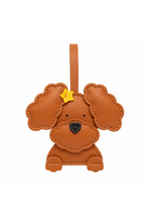 A brown leather poodle-shaped bag charm with a small yellow star on its forehead, shown against a plain white background.