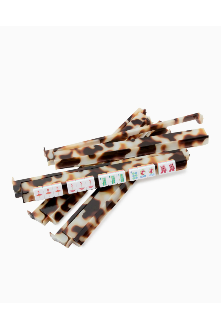A set of chopsticks with a brown and beige leopard print pattern, featuring small Mahjong tile graphics on the tips, arranged on a plain white background.