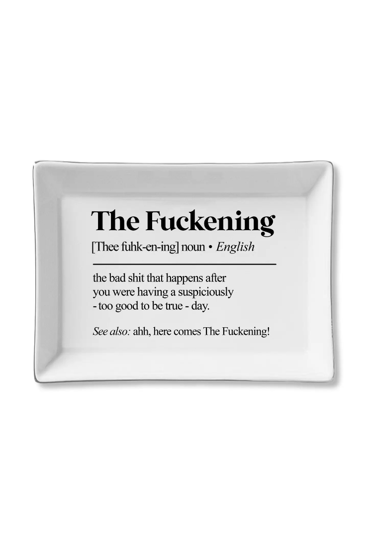 A white rectangular ceramic serving tray with rounded corners, featuring black printed text on the front that reads 'The Fuckening' followed by a dictionary-style definition. The tray is photographed on a clean white background.