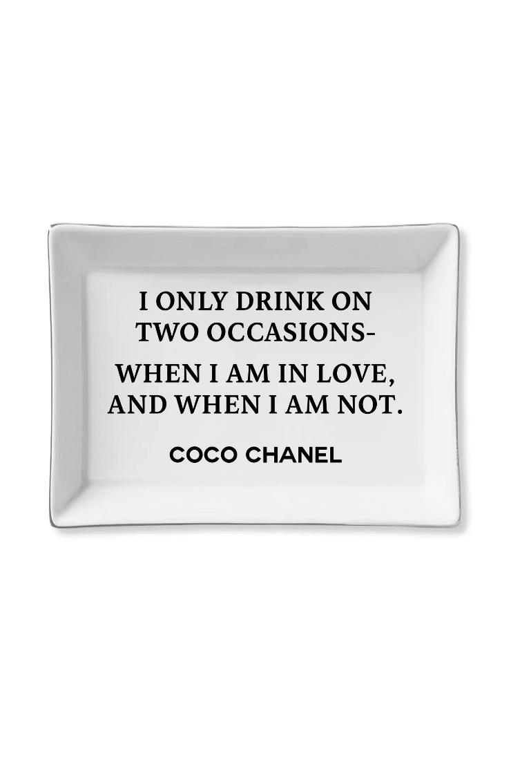 A white rectangular ceramic serving tray with rounded corners, featuring black printed text that reads 'I ONLY DRINK ON TWO OCCASIONS- WHEN I AM IN LOVE, AND WHEN I AM NOT. COCO CHANEL'.