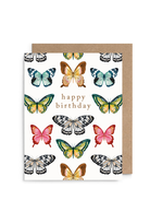 A white birthday card with a kraft envelope behind it, decorated with colorful illustrated butterflies and the words 'happy birthday' in gold lettering.