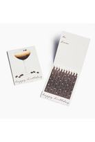 A birthday candle set with a matching card. The card features an illustration of a cocktail with coffee beans and the text 'happy birthday', while the candle holder contains multiple birthday candles with printed names on the white packaging.