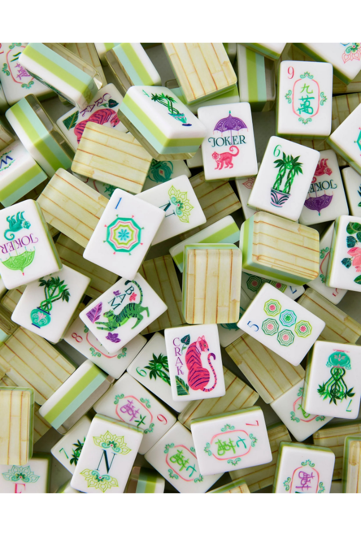 Collection of colorful miniature tiles with various designs on a wooden surface