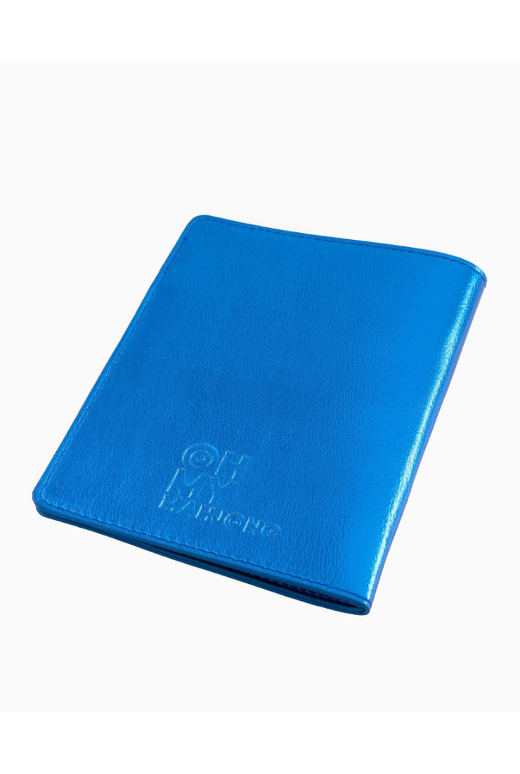 Blue notebook with 'Qu'my' branding on a white background