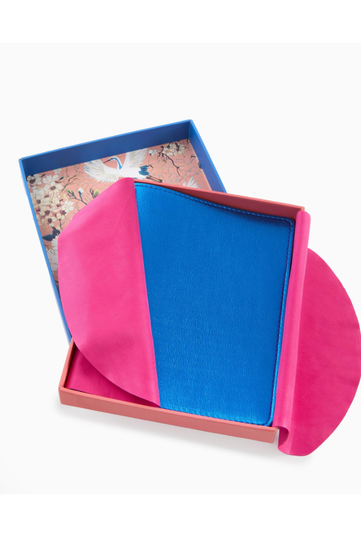 Color-blocked pink and blue card in an open box with floral design