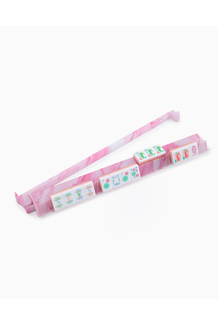 Pink hair tie with small boxes on a white background