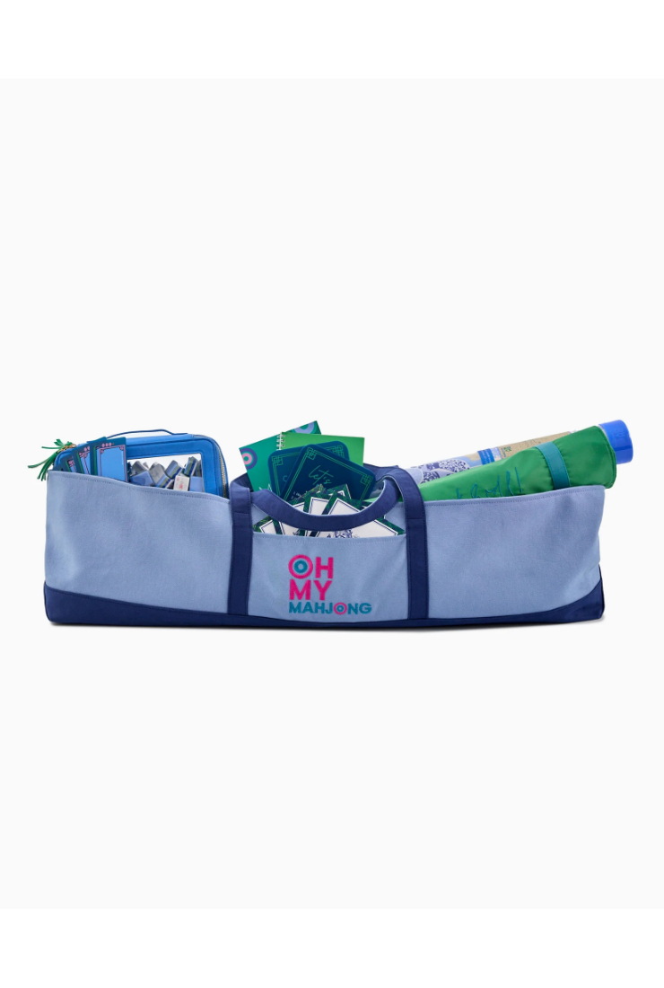 Blue tote bag with green and blue items on a white background