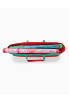 Colorful toy suitcase with rolled-up fabric inside on a white background