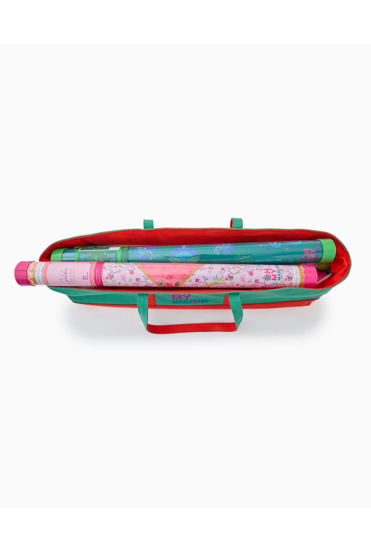 Colorful toy suitcase with rolled-up fabric inside on a white background