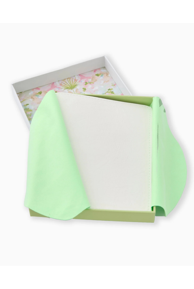 A mint green paper gift wrap or tissue paper draped over an open white box with a pastel floral patterned interior, shown on a clean white background.