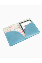 A light blue faux-leather passport cover with a floral patterned interior lining and a clear ID window, shown on a plain white background.