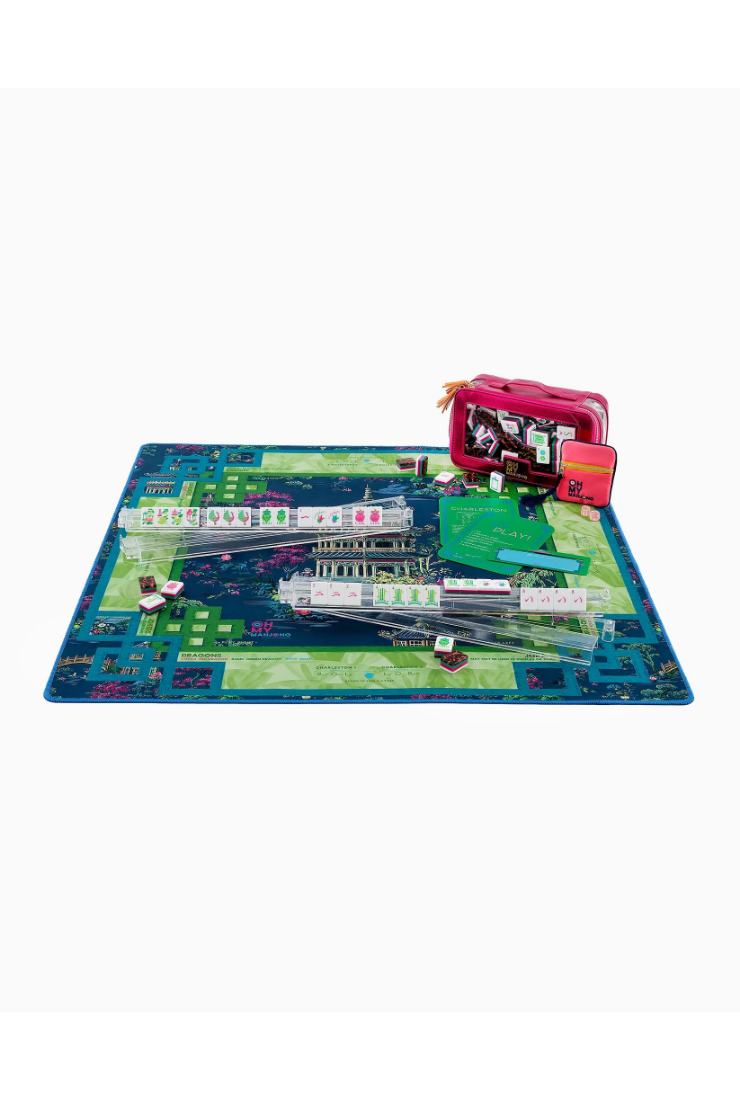 Board game with colorful mat and toy train set on a white background