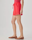Person wearing red shorts on a plain background