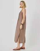 Woman wearing a brown slip dress on a white background