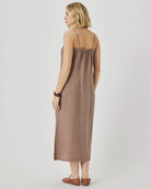Woman wearing a brown slip dress on a white background