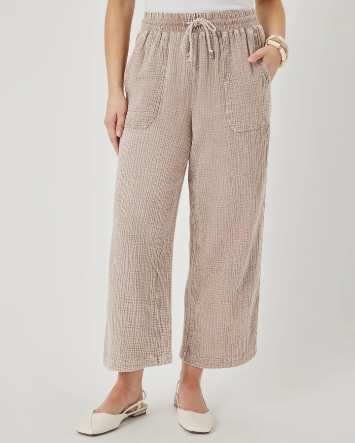 Person wearing plaid pants on a plain background