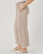 Person wearing plaid pants on a plain background