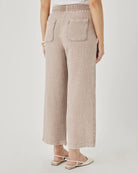 Person wearing plaid pants on a plain background