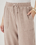 Beige checkered pants with a drawstring on a plain background