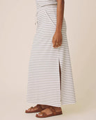 Person wearing a striped skirt with a plain background