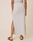 Person wearing a striped skirt with a plain background