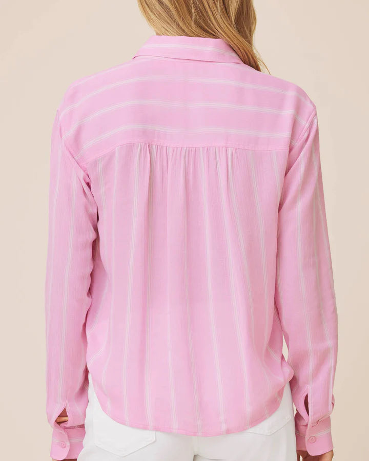 Pink striped shirt worn by a person on a beige background