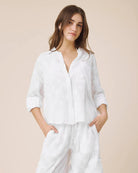 Woman wearing a white outfit on a beige background