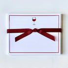 Note card with a red ribbon and a wine glass illustration on a white background