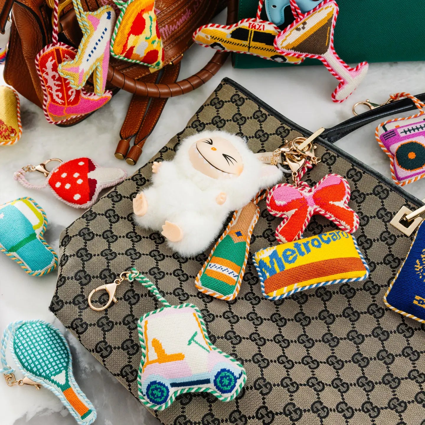 Colorful keychains and charms on a patterned surface