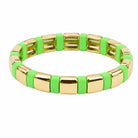 Gold and green bracelet on a white background