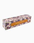 A rectangular product box with a tortoiseshell pattern in shades of purple, orange, and brown, featuring a central gold label that reads 'BLOND TORTOISE'.