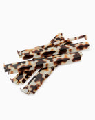 Set of tortoiseshell-patterned straws on a white background