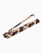 Tortoiseshell eyeglasses frames shown open and closed on a plain white background.