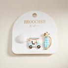 Two checkered golf cart brooches on a 'Brooches by Influence' card.